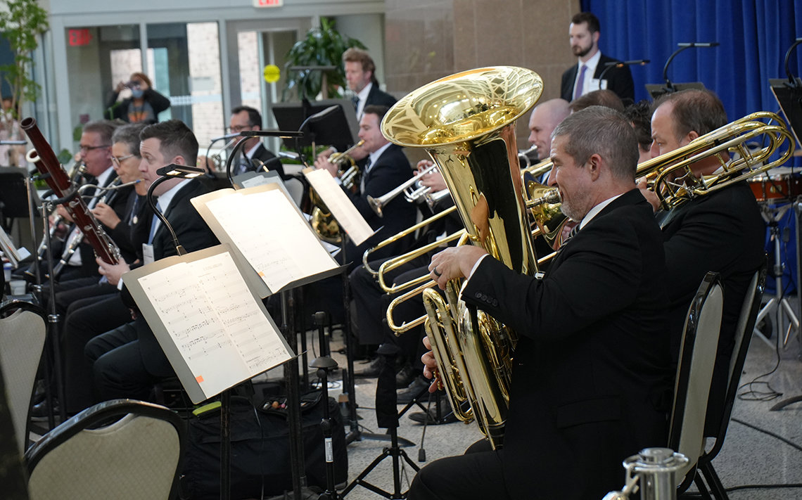 From the side, musicians on tuba, trombones and bassoon