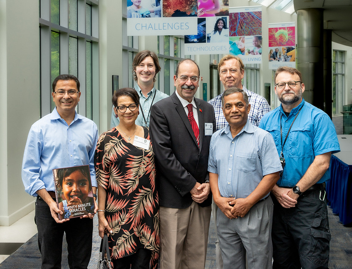 Verma and colleagues pose together in the hallway in Natcher.