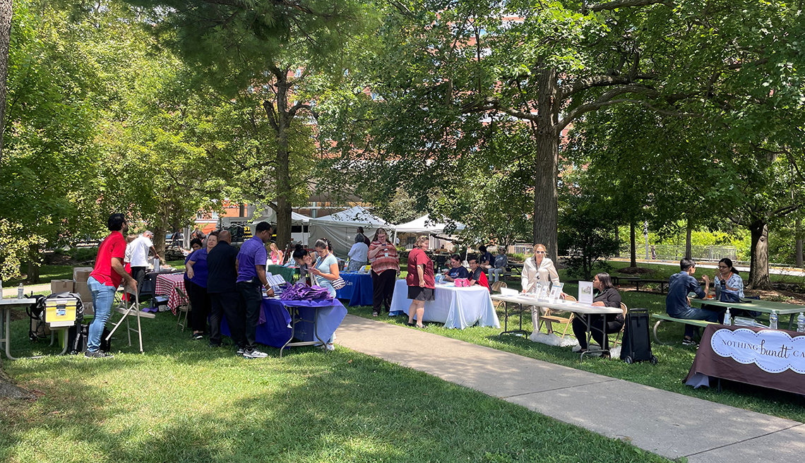 Tables and tents with edibles and other goodies line a pathway on the south lawn behind the Clinical Center.