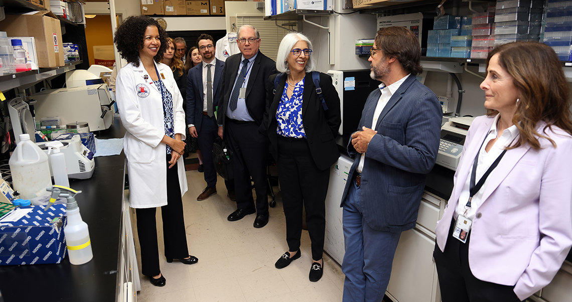 NHLBI researchers and Tabak brief Prabhakar in the lab.