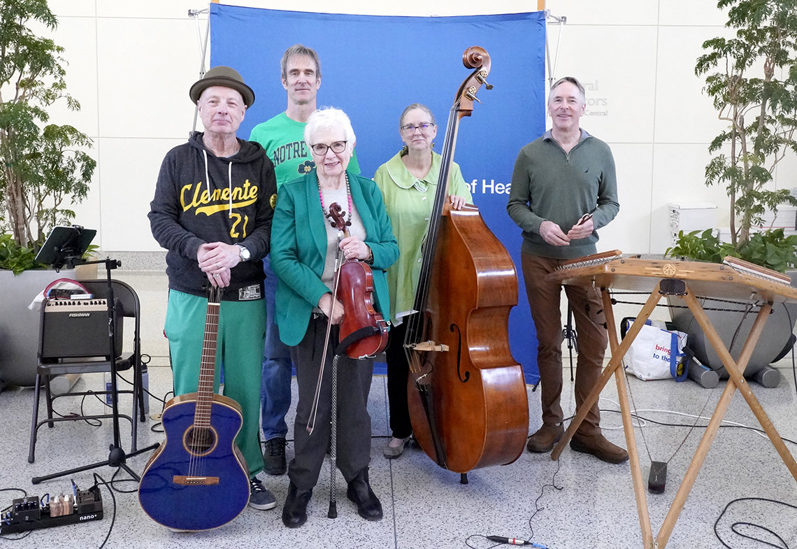 The Dulcetones pose for a photo with their instruments.