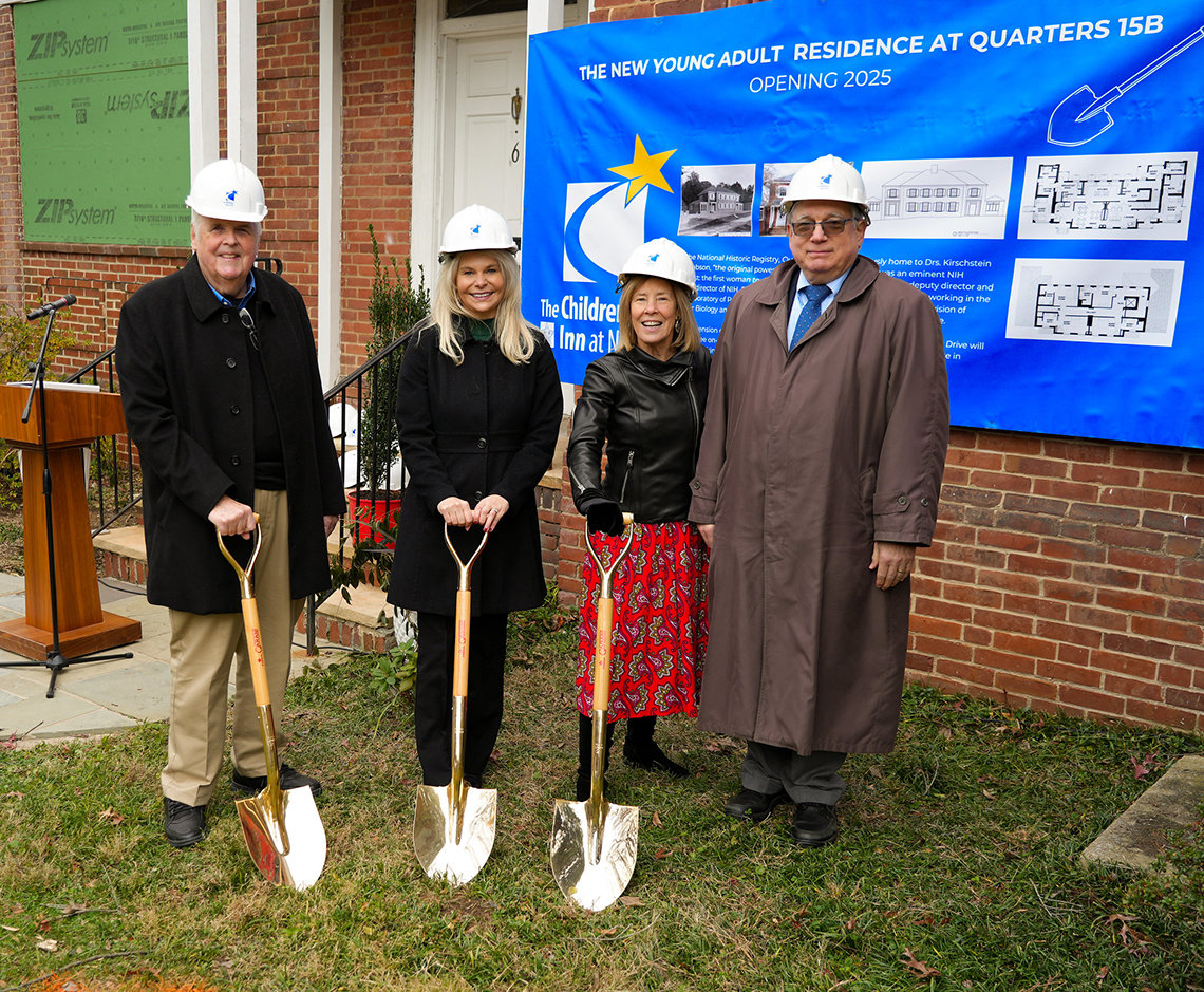 The event's speakers hold ceremonial gold shovels in front of the quarters