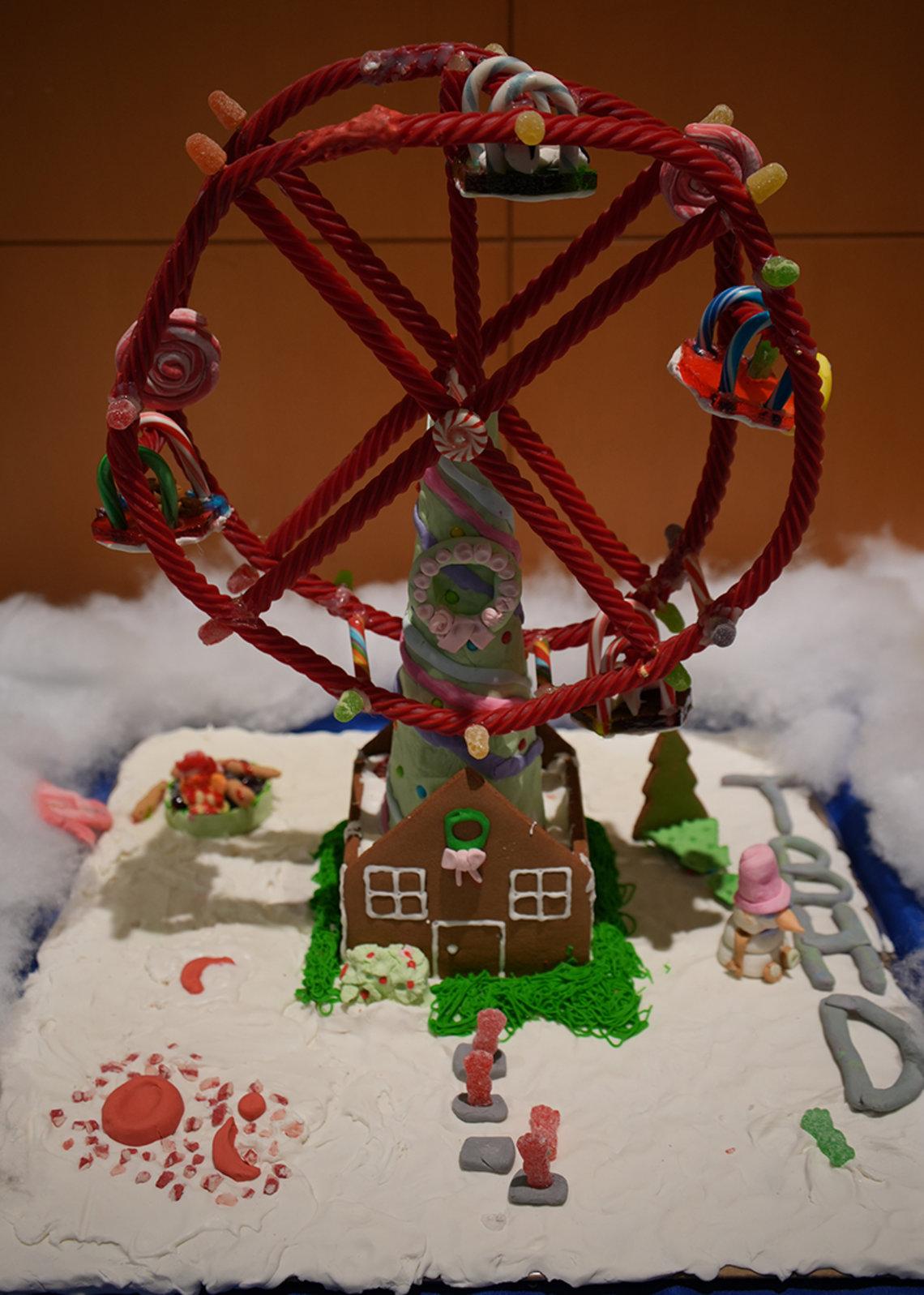 Gingerbread house with a large ferris wheel atop made from red licorice