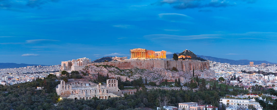 Athen's Parthenon sits on a hill at dusk