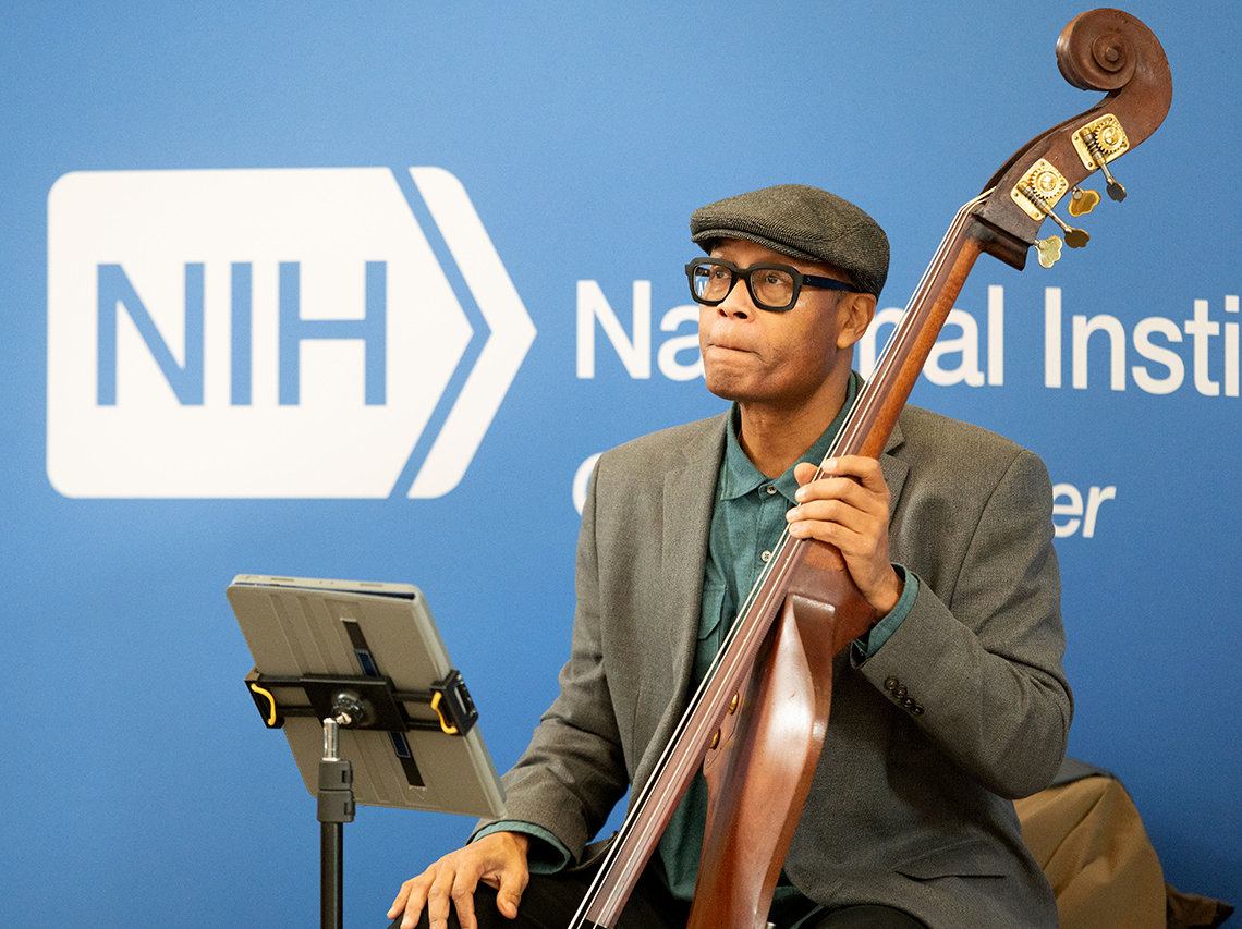 Black man seated with upright bass