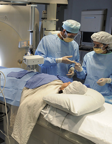 Doctors at the Clinical Center prepare to begin interventional radiology on a patient.