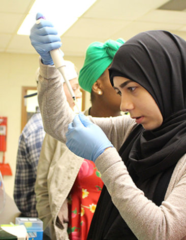 Alhabib practices pipetting in a lab
