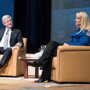Rubins and Collins chat, seated on stage in Masur Auditorium.