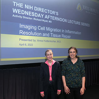 Schor and Huttenlocher stand in front of the lecture's title slide.