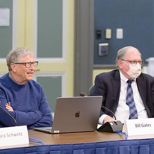Seated at a conference table, Schwetz, Gates and Tabak