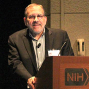 Sanes behind NIH podium