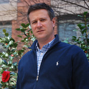 Hartz poses in front of rose bush in garden outside the Clinical Center 