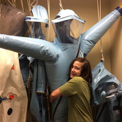 Jonah Gillespie, age 13, helps test the safety seals of the positive pressure personnel protection suit in a BSL-4 laboratory. PHOTO: MEREDITH DALY