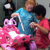 Youngsters adapt a ride-on toy car for a child with disabilities during the GoBabyGo workshop hosted by NICHD. The GoBabyGo lab at the University of Delaware, funded by NICHD, designs and modifies cars to get kids moving. PHOTO: MEREDITH DALY