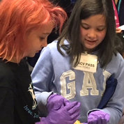 At the Brain Science Fair held at the Neuroscience Center in Rockville, Zoey Karbeling (l, age 7) and Jaden Karbeling (age 10), granddaughters of NIDCR’s Ann Poritzky, handle a sheep’s brain. PHOTO: CHIA-CHI CHARLIE CHANG