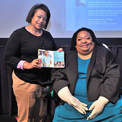 Crystal Emery (r) with EDI’s Kay Johnson Graham, holding Emery’s recent book.