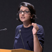 Saini speaks at podium