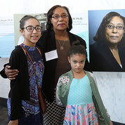 Dr. Emmeline Edwards of NCCIH and her granddaughters next to poster with her photo