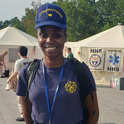 A smiling Dr. Iman Martin out in the field at a FEMA training