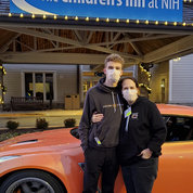 Luke and his mom Jen pose next to the GT-R, painted orange for kidney cancer awareness. PHOTO: BRUCE H. LEE