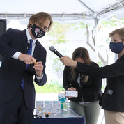 NIBIB director Dr. Bruce Tromberg demonstrates Ellume’s Covid-19 antigen test that displays its result in 15 minutes via a smartphone app. Sen. Tammy Baldwin (D-WI) extends the microphone, while NIBIB health science policy analyst Dr. Patricia Wiley holds the paired smartphone. PHOTO: CHIA-CHI CHARLIE CHANG