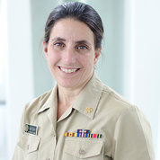 Headshot of a smiling Saydah in her beige Public Health Service uniform