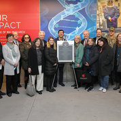 In the underground passageway, representatives from several organizations that were instrumental in concept and construction of the MD 355 Crossing Project gather for a photo in front of one of two murals. PHOTO: CHIA-CHI CHARLIE CHANG