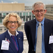 Bianchi and Lane stand smiling together outside on a rooftop on the NIH campus.