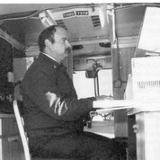 In 1990, Assistant Fire Chief Gary Hess checks for chemical data through the computer located in a command mobile van designed by the firefighters and used in responding to all emergency calls.