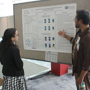 Ivan Rajen, University of California, San Diego, presents his lab’s research as Maria Mendez-Santos, Northwestern University, looks on. PHOTO: NIBIB