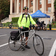 NIMH’s Jerry McGuire poses with bike in front of Bldg. 1