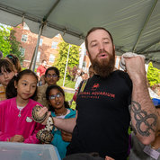 Two friendly snakes were just some of the animal visitors brought on campus for Earth Day by Drew Roderuck (r) from the Maryland Reptile Conservation Center. PHOTO: Leslie Kossoff.
