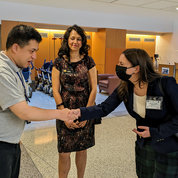 Project SEARCH graduate Van Berg (l) greets Maryland State Delegate Sarah Siddiqui Wolek (c) and her chief of staff, Claudia Fess. PHOTO: Erin Bryant/NINDS