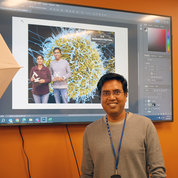 Dr. Kumar Ashish smiles in the NIH Library’s recording studio for a souvenir postcard as part of this year’s technology demo. PHOTO: DANA TALESNIK