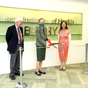 Schor cuts the ribbon to the exhibit while Gottesman and Wong watch