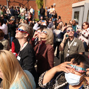 Employees gather outside the NIH Library to watch the spectacle through protective glasses. PHOTO: CHIA-CHI CHARLIE CHANG