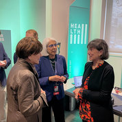 Dr. Arati Prabhakar (c), director of the White House Office of Science and Technology Policy, and Bertagnolli chat with another Demo Day attendee.