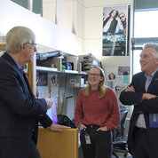 Former NIH Director Dr. Francis Collins (l), now serving as a distinguished investigator at NHGRI, and Erin Mansell, a postbaccalaureate fellow, talk with McAuliffe. PHOTO: CHIA-CHI CHARLIE CHANG