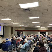Lorsch talks during the Q&A with Asbury resident and former NIH-funded researcher Dr. Frederick “Fred” Kauffman. Now a professor emeritus of pharmacology and toxicology at Rutgers University, Kauffman says he “owes [his] entire 30-year career” to NIH. PHOTO: OWEN OLDER