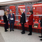 Discussing features of the exhibit are (from l) Dr. Anthony Fauci, former NIAID director; Diane Dowling, Alter’s wife; the honoree; Dr. James Gilman, chief executive officer of the Clinical Center; Dr. Monica Bertagnolli, NIH director; and Dr. Lawrence Tabak, NIH principal deputy director. PHOTO: CHIA-CHI CHARLIE CHANG